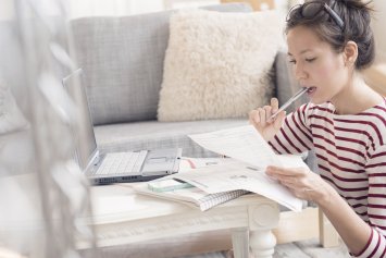 Woman looking at paycheck